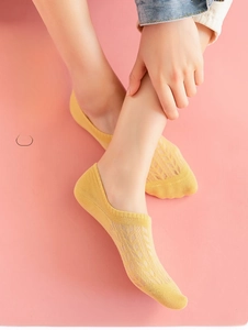 Detailed mesh knit texture of breathable cotton low cut socks in bright yellow