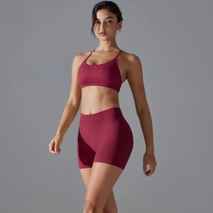 Two-piece burgundy seamless yoga set with cross back sports bra and high waist shorts
