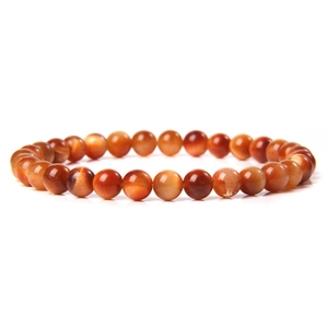 Detailed view of 6mm red agate beads showing natural silk luster and smooth texture