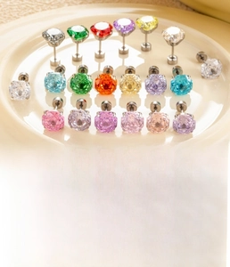 Detailed view of 8mm multi-colored zircon screw-back earrings set in polished steel studs