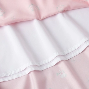 Detail of floral satin fabric with smooth white lining and high-quality stitching
