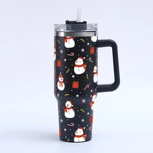 Detail of 40oz black tumbler with Christmas snowman pattern, handle, and straw lid