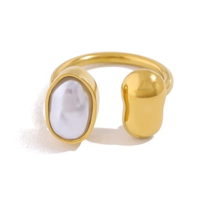 Detail of irregular white baroque pearl and gold textured sphere on open ring