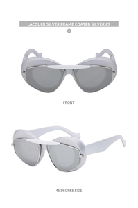 Macro view of silver futuristic cat-eye sunglasses with shield frame and white top bar