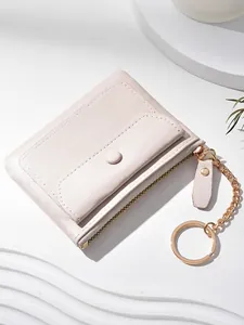 Portable light pink faux leather mini wallet with gold zipper and keychain for women