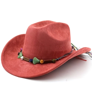 Detail of rust red suede cowboy hat featuring a colorful stone band and ethnic woven rope