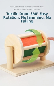 Close-up of spinning wooden textile drum Montessori toy with vibrant colored panels