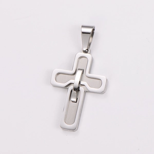 Close-up of a polished silver stainless steel cross pendant with a brushed inner cross