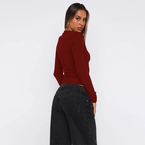 Detail of slim fit dark red cardigan featuring button closure and ribbed texture design