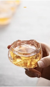 Close-up of Japanese hammered texture glass tea cup with amber frosted non-slip grip