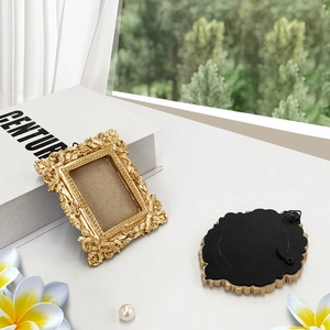 Detailed view of gold vintage baroque photo frame with intricate floral carvings and stand