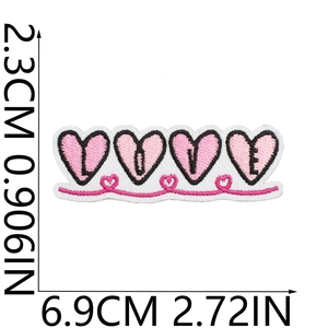 Detailed view of pink heart LOVE embroidered patch with size markings in cm and inches