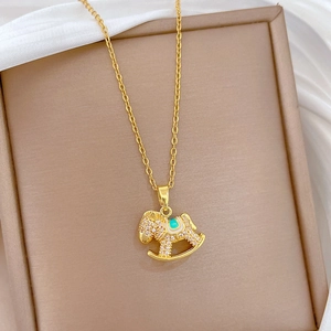Close-up of a gold-plated necklace with sparkling stones in a luxury jewelry box
