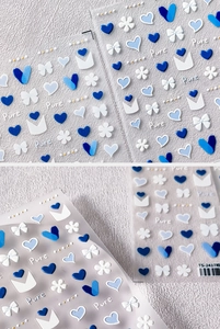 Macro detail of TS-2417 blue heart 3D embossed nail stickers with bow and floral motifs