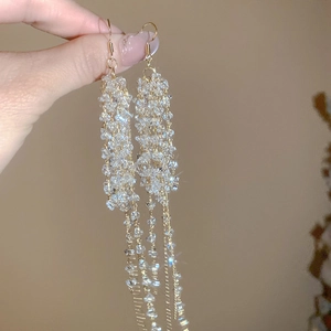 Close-up of elegant French crystal beaded tassel earrings with gold-toned hooks