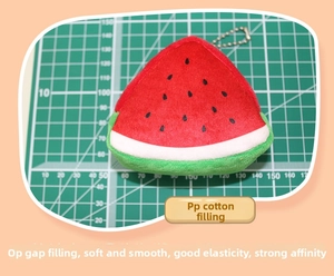 Detail showing the soft plush watermelon coin purse with PP cotton filling and a metal chain