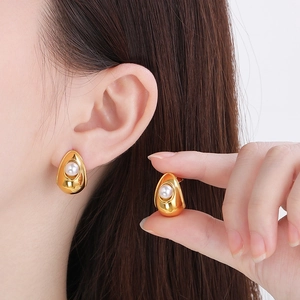 Minimalist gold pearl stud earrings with a sleek teardrop design for a luxury look