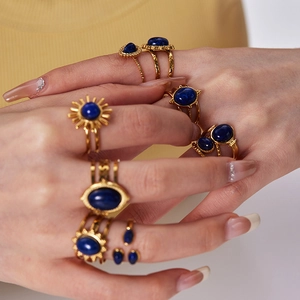 Close-up of vintage gold stainless steel rings set with natural blue lapis stones