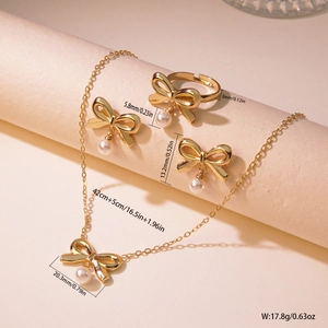 Detailed view of gold bow jewelry set with pearls showing product sizes and weights