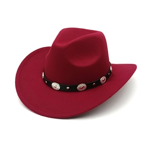 Close-up of wine red western cowboy hat with black belt and silver metal studs