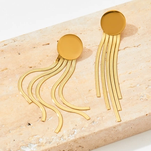 Golden round stud earrings featuring elegant flat snake chain tassels on stone background