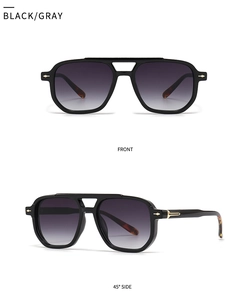 Detail view of black square frame sunglasses with grey lenses and gold metal accents
