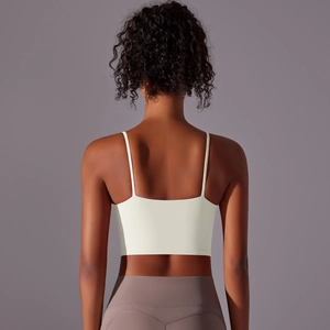 Detail view of the cream white sports bra back with thin straps and elastic fit