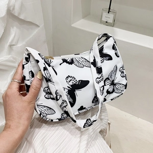 Fashionable white underarm bag with black butterfly print and secure zipper closure