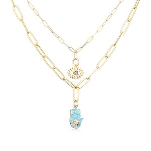 Detailed macro view of 18K gold-plated double layer necklace with Hamsa hand and evil eye