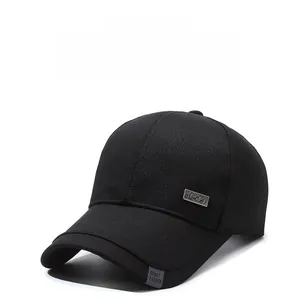 Close-up of black cotton baseball cap showing the SPORT metal emblem and side fabric tag