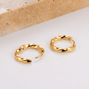 Elegant gold twisted hoop earrings with a polished minimalist stainless steel texture