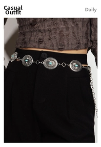 Detailed view of bohemian waist chain with engraved metal plates and turquoise stones