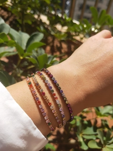 Detailed view of colorful zircon tennis bracelets with multi-color stones in prong setting