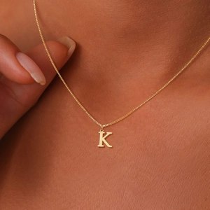 Elegant gold-tone box chain necklace featuring a minimalist capital letter K pendant