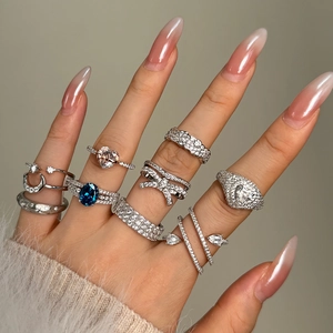 S925 sterling silver ring set with blue gemstone heart and bow designs on hand