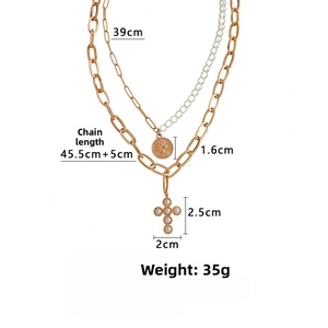 Detail view of double-layer gold necklace with coin and pearl cross pendants with dimensions