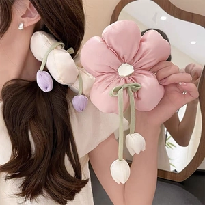 Detailed view of oversized floral scrunchies with plush sponge filling and tulip charms