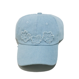 Denim baseball cap for women with floral embroidery and adjustable strap in light blue