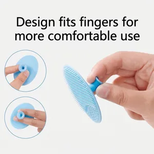 Light blue silicone baby head brush with ergonomic finger grip for scalp cleansing