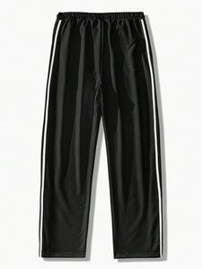 Detail of black jogger pants featuring classic side white double stripes and elastic waist