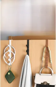 Detailed view of over-the-door hooks in black, white, and brown for bags and coats