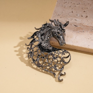 Macro detail of retro pony brooch featuring black rhinestones and hollow filigree work