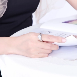 Detail of silver hammered texture ring with large round-cut diamond on woman's hand