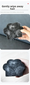 Close-up of black paw-shaped sponge hair remover for cleaning pet fur on sofas