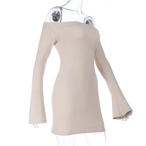 Detail shot of beige knit fabric texture on a long sleeve off-shoulder dress