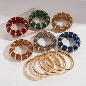 Chunky acrylic resin bracelets and gold metal bangles set in various colors