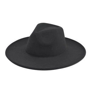 Close-up of a black wide brim wool fedora hat with a smooth felt texture and crown indent