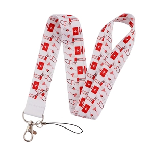 Detail of medical theme lanyard with stethoscope and first aid icons on white polyester