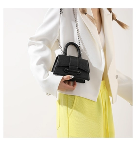 Chic black pebbled leather mini handbag with silver bead chain and belt buckle detail
