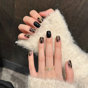 Short square cat eye press-on nails in black and brown ink splash style with glossy finish
